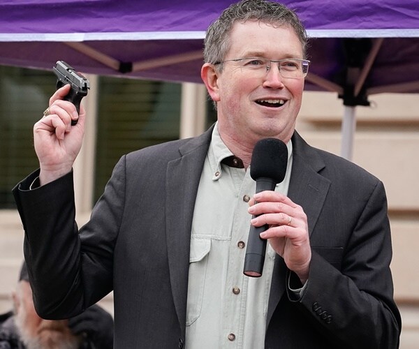 rep. thomas massie holds up his pistol