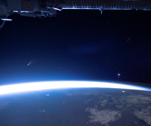 comet is seen from space above earth