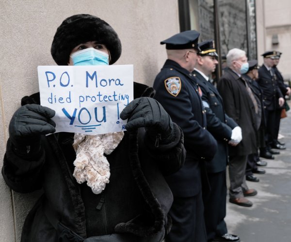 officers and mourners gather for a funeral of a police officer