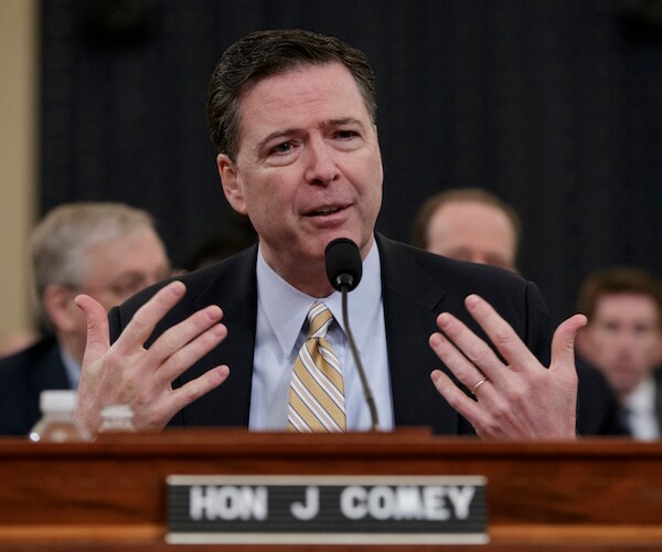 james comey gestures with both hands while capitulating during a congressional hearing