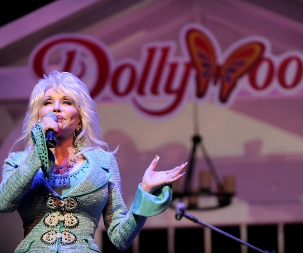 dolly parton speaks into a mic