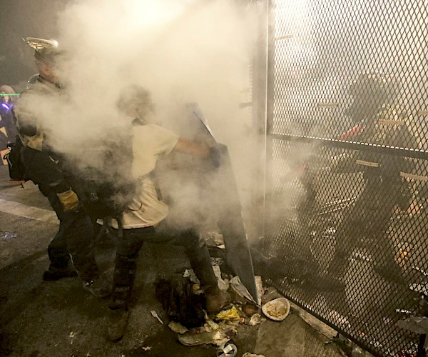 federal police agents tear gas violent demonstrators