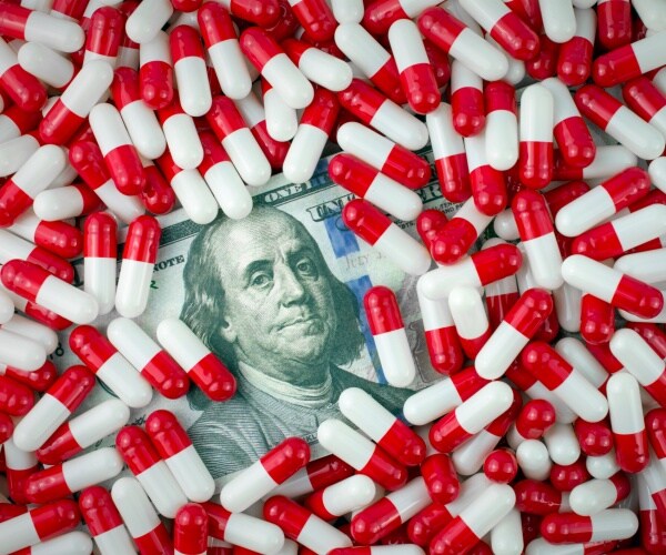 generic drug prices money with red and white pills 