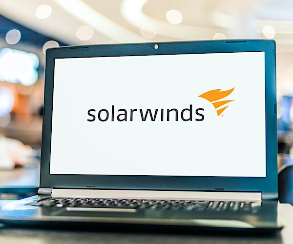 a laptop shows the solarwinds logo on its screen