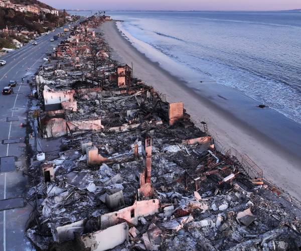 rows of burned houses next to the ocean