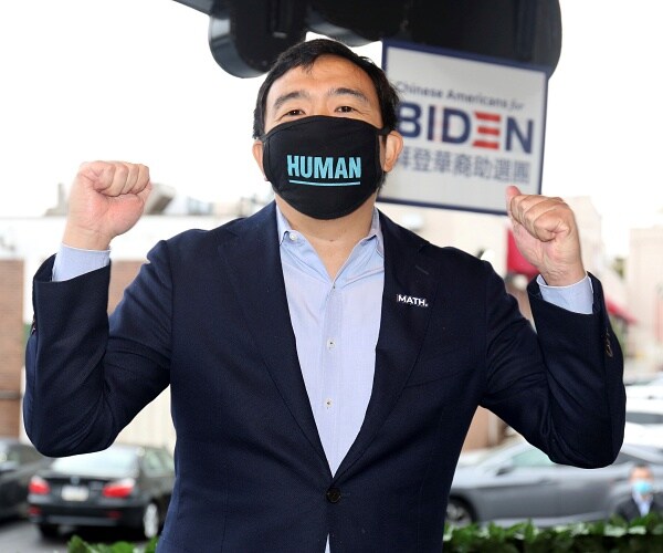 andrew yang raises his fists