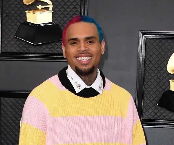 chris brown stands on red carpet