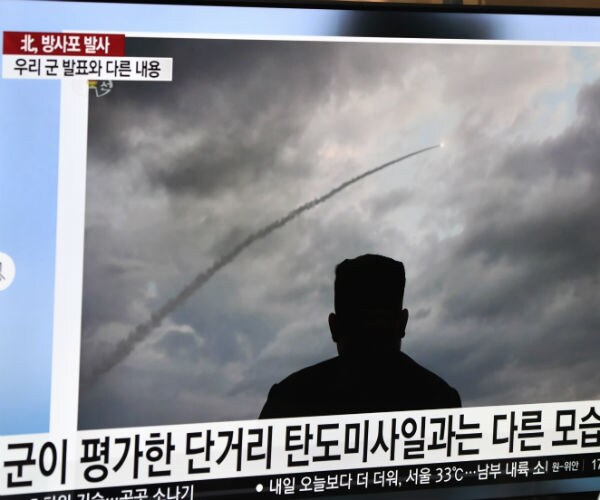 a television image of kim jong un watching a missile launch