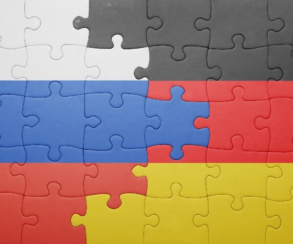 flags of germany and russia interlocked on a puzzle