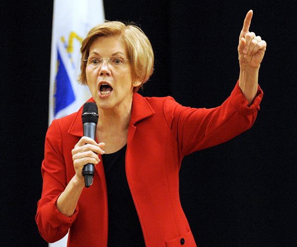 massachusetts democratic senator elizabeth warren points up with her left index finger while speaking into a mic