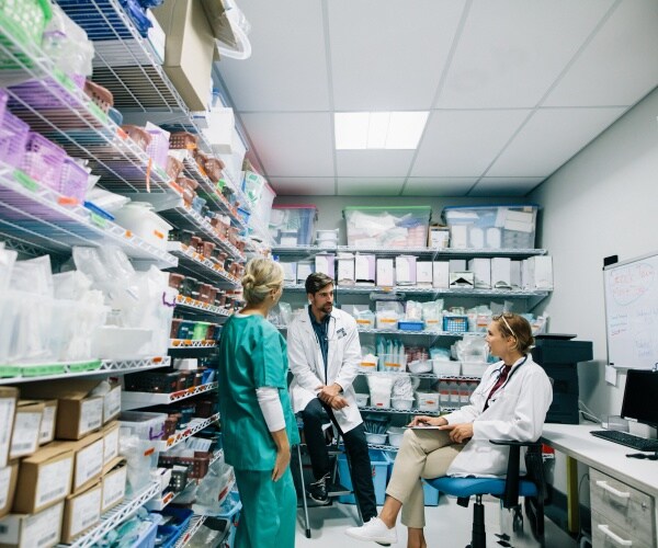 medical staff talking in hospital pharmacy