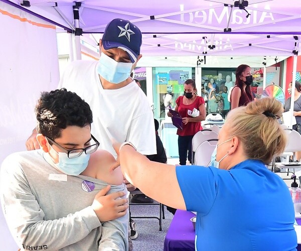 Man receives his COVID-19 vaccine from a registered nurse.