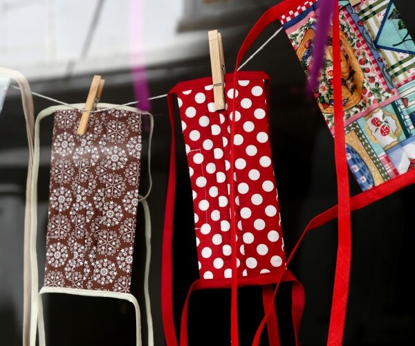 cloth masks with brown and white floral print, red polka dot print and quilt print