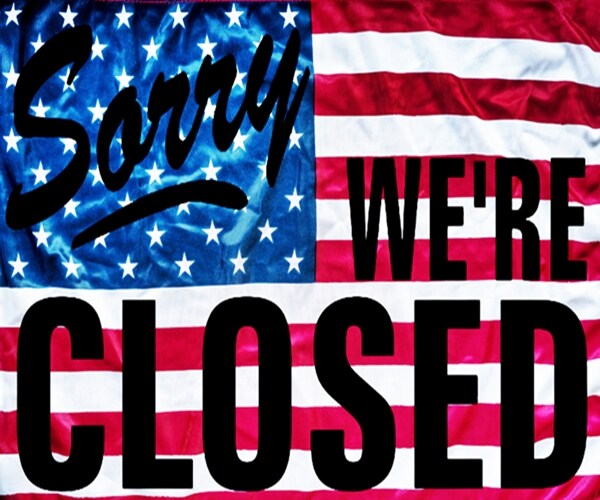 government shutdown represented by a sorry we`re closed sign outline with american flag background 