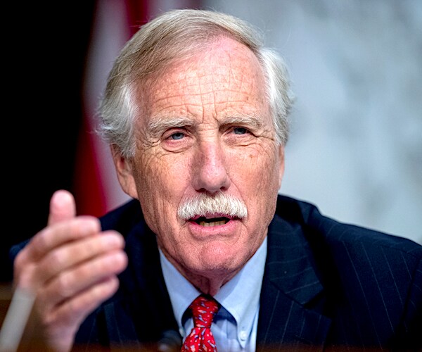 independent maine senator angus king gestures with his left hand while sitting during a senate hearing