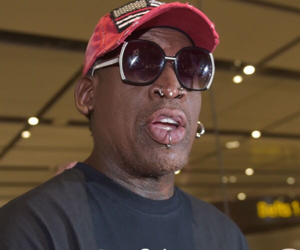 dennis rodman is shown wearing a black peacestarts shirt