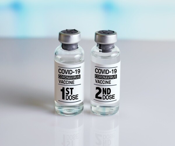 photo of two vials of vaccine labeled First Dose, Second Dose