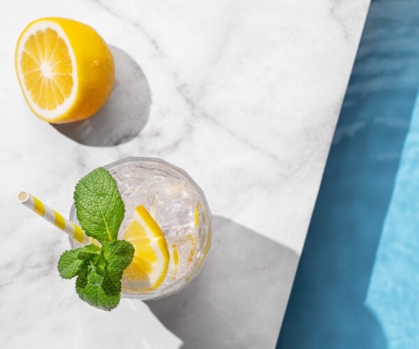 mint in a drink with lemon by a pool