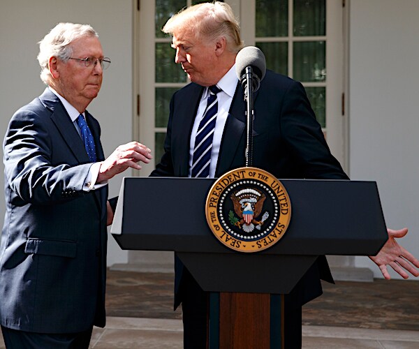 mitch mcconnell approaches the podium as president donald trump departs it