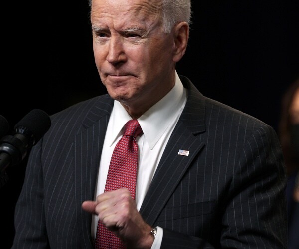 joe biden speaks into microphone