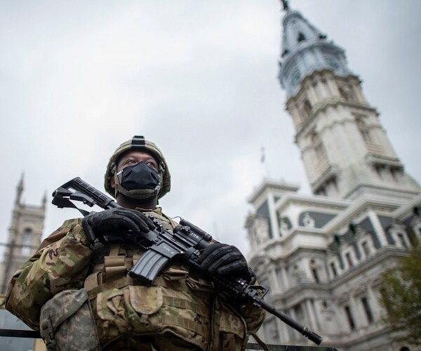 national guard member stands in front of philadelphia city hall