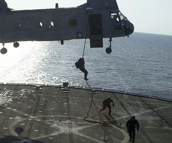 navy seals train with a military helicopter