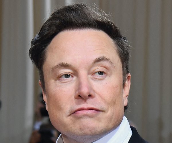 elon musk in a head shot faces the camera with his eyes to the left