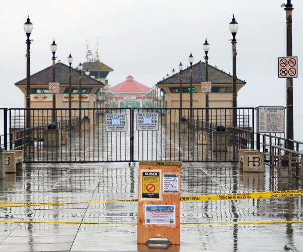 a pier in huntington beach, california, is closed because of the coronavirus pandemic