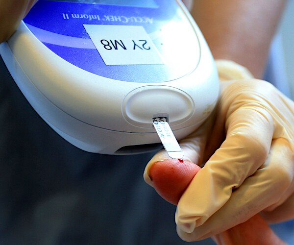 a nurse giving a patient a diabetes test