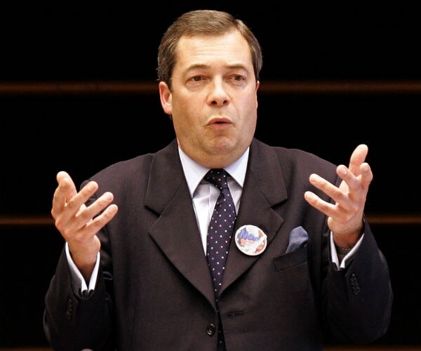 nigel farage, wearing a suit, gestures as he speaks during a debate