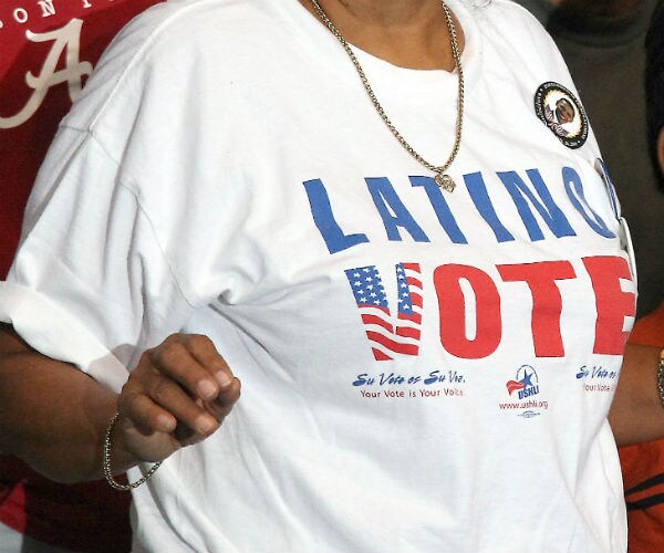 a woman wearing a 'LATINO VOTE' shirt is shown in red, white and blue letters