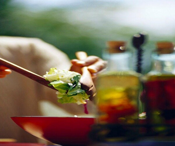 close up of person eating a salad