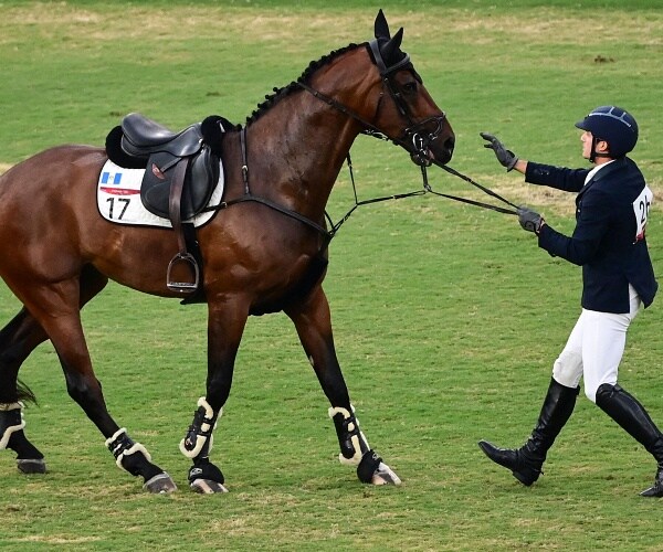 man talks to horse after falling off during competition 