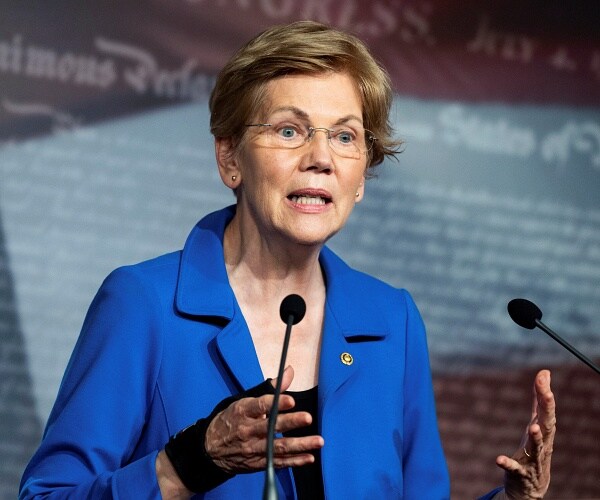 elizabeth warren speaks into microphone