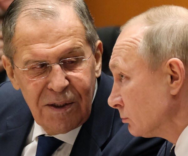 lavrov and putin speaking together wearing suits