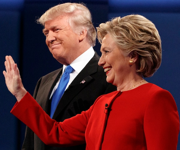 president donald trump smiles wide standing to the right of hillary clinton as she waves to the crowd