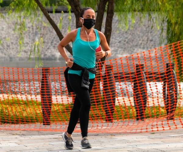 woman running in mask