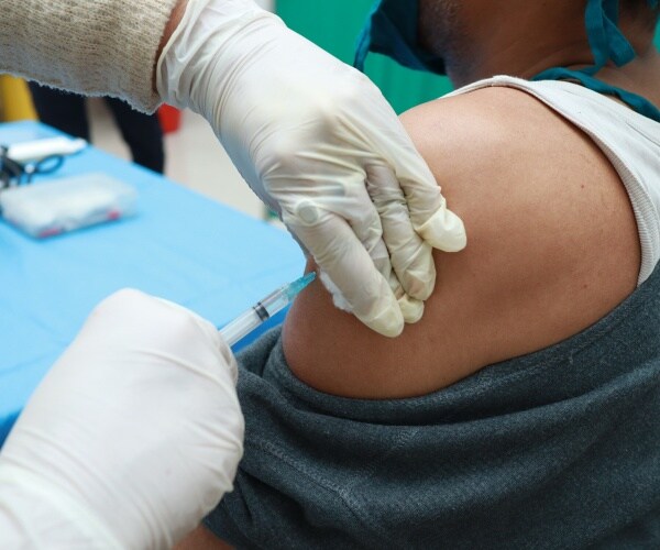 person getting vaccine in arm