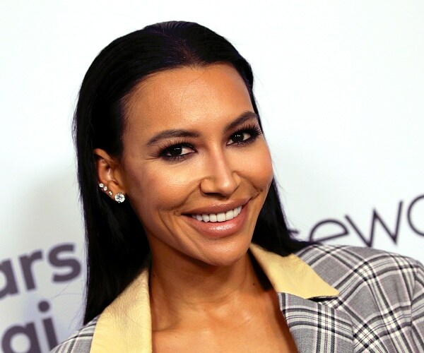 naya rivera stands on red carpet