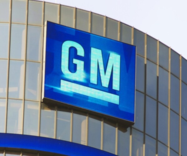 gm corporate logo in blue on silver building side