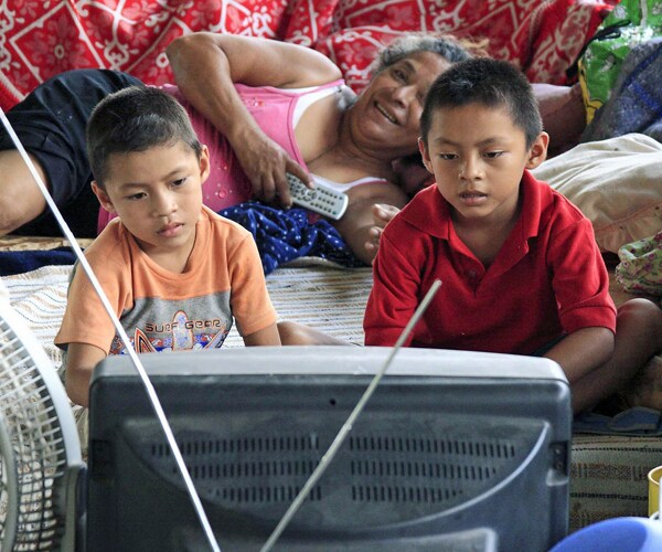 two children watch television