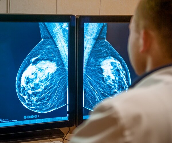 physician examining mammogram results