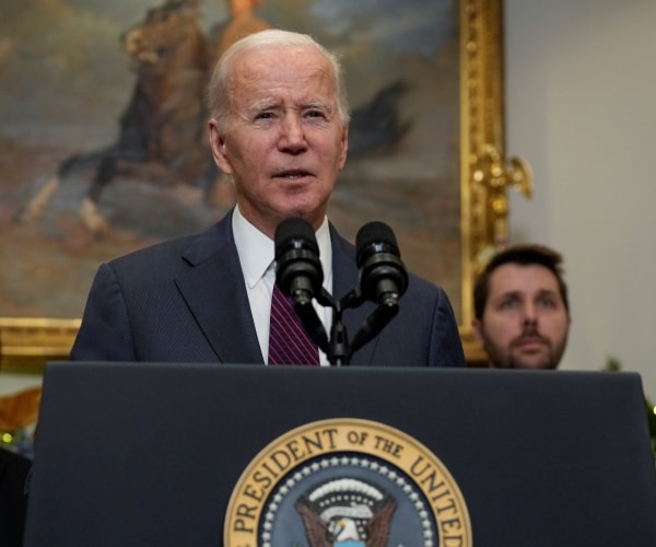 joe biden speaks into a microphone