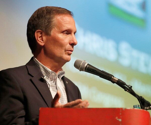 rep.chris stewart speaks at a town hall meeting.