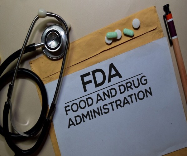 FDA on a paper on a clipboard, with pencil and medication