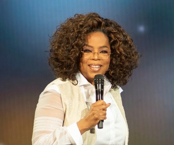 oprah winfrey speaks into mic onstage