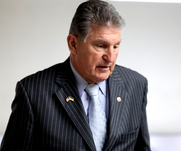 joe manchin looks on during a press conference