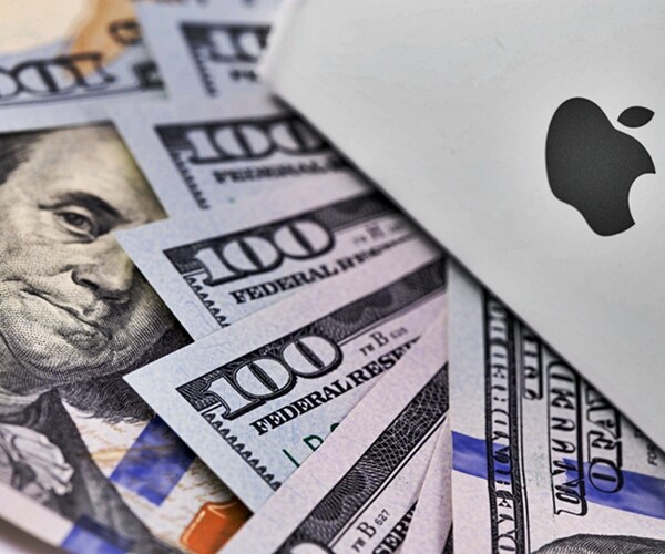 apple logo on the box, one hundred dollar bill scattered