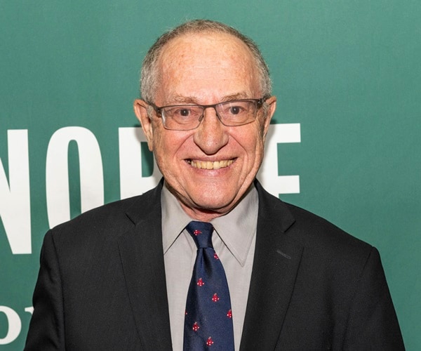 Alan Dershowitz smiles for a photo at barnes and noble