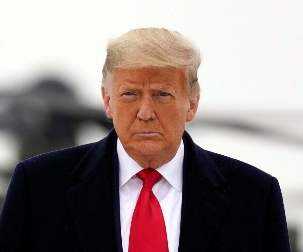 donald trump walks across tarmac